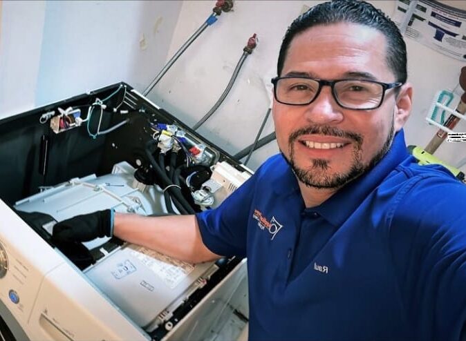 tech smiling while appliance repair